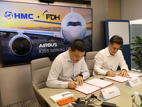 Cody Ho and Pierre Jacquet Francillon signing the agreement.