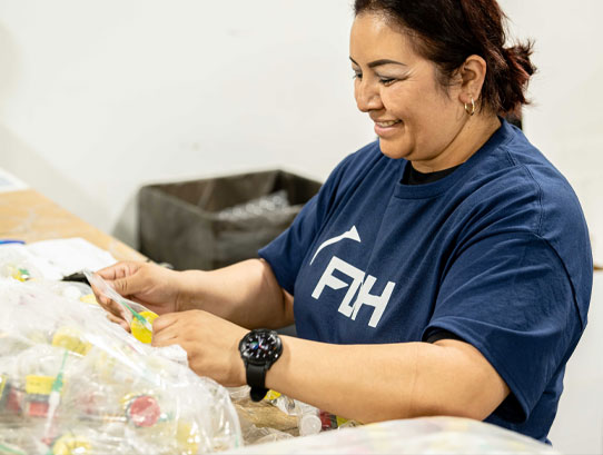 FDH Electronics employee packaging products to ship out.
